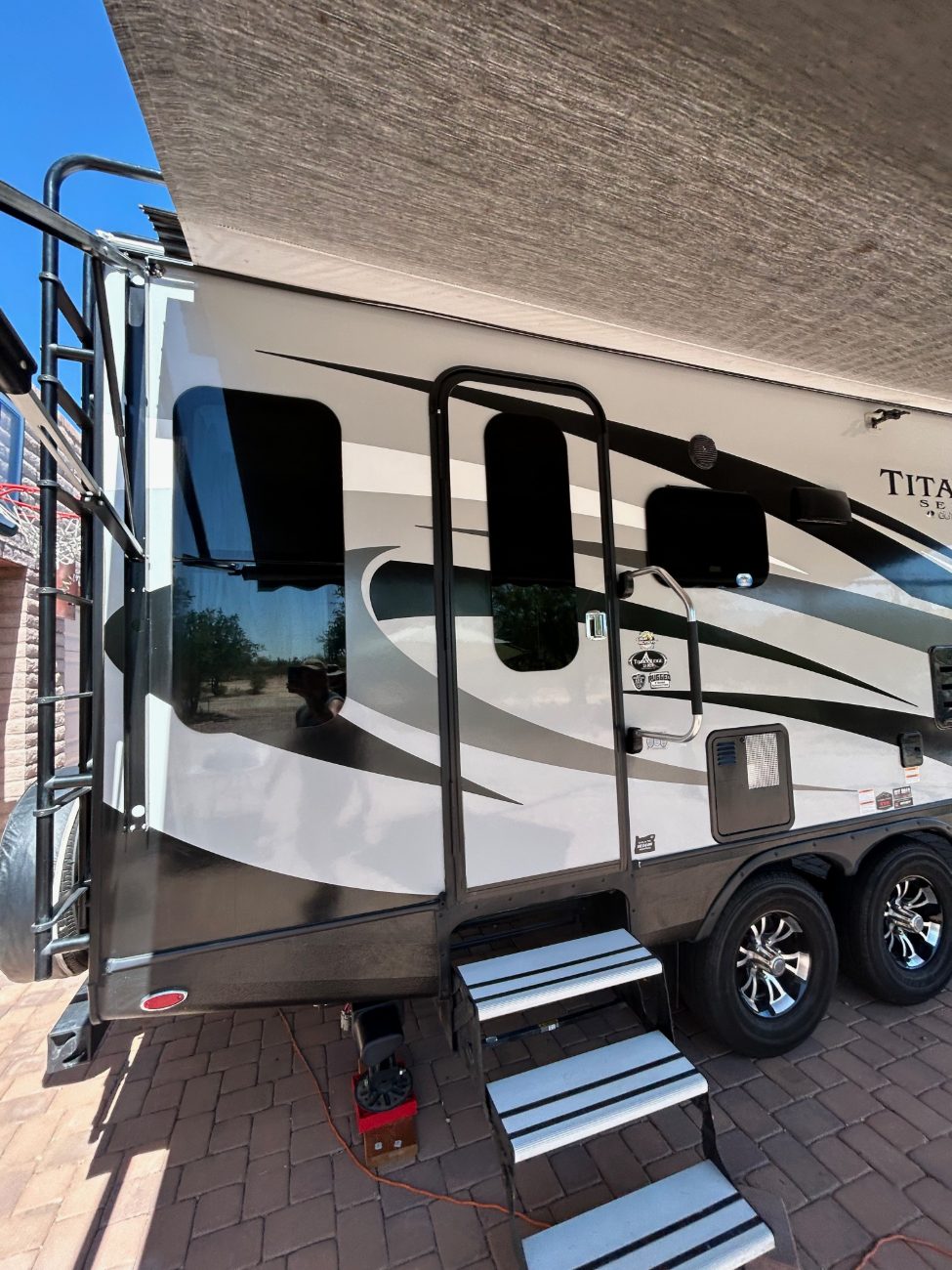 Close view of a travel trailer's gelcoat and graphics after a Premium Shine wash in Tucson