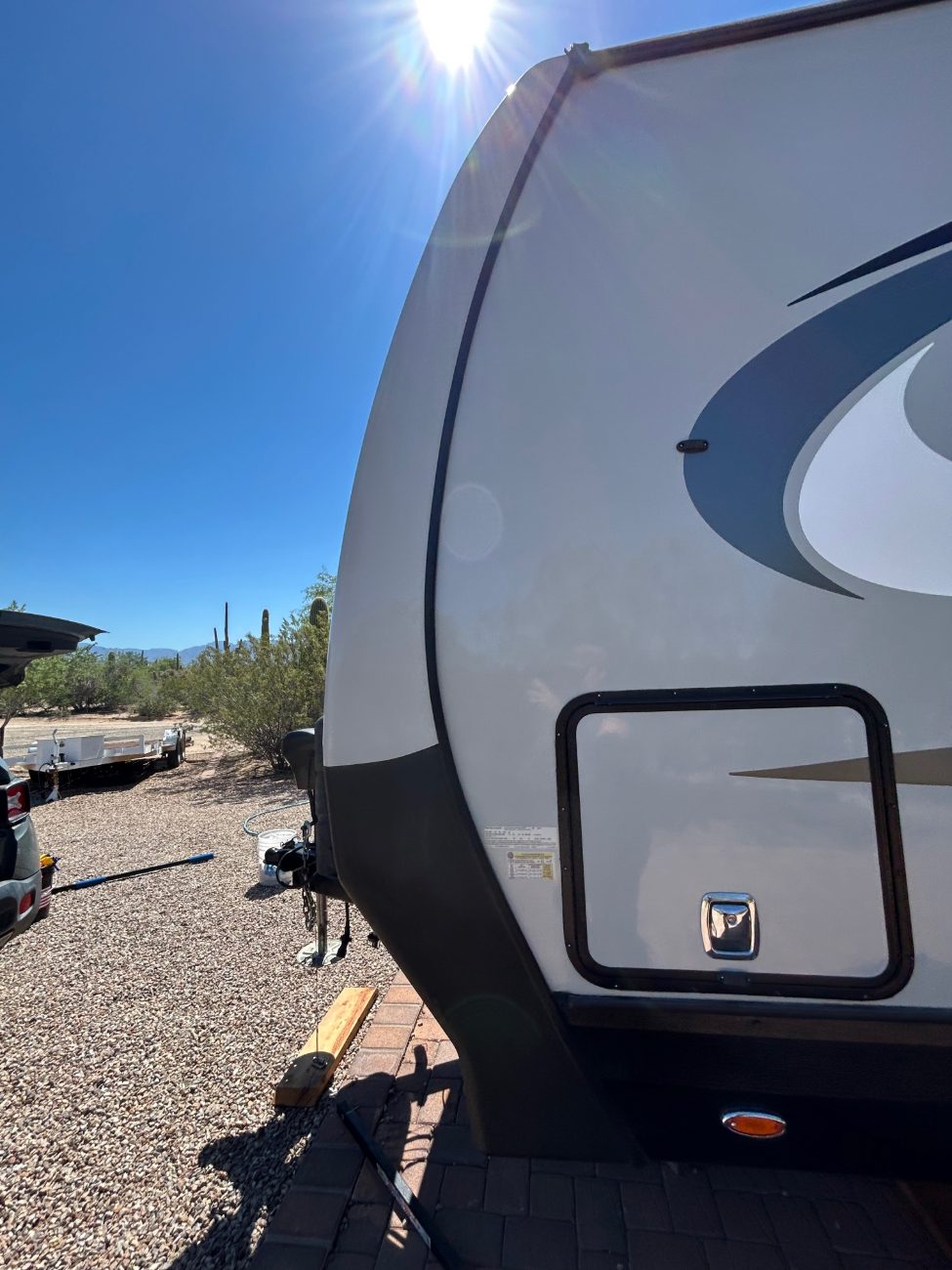 Mobile RV wash in progress at a Southern Arizona property with saguaros and mountains behind